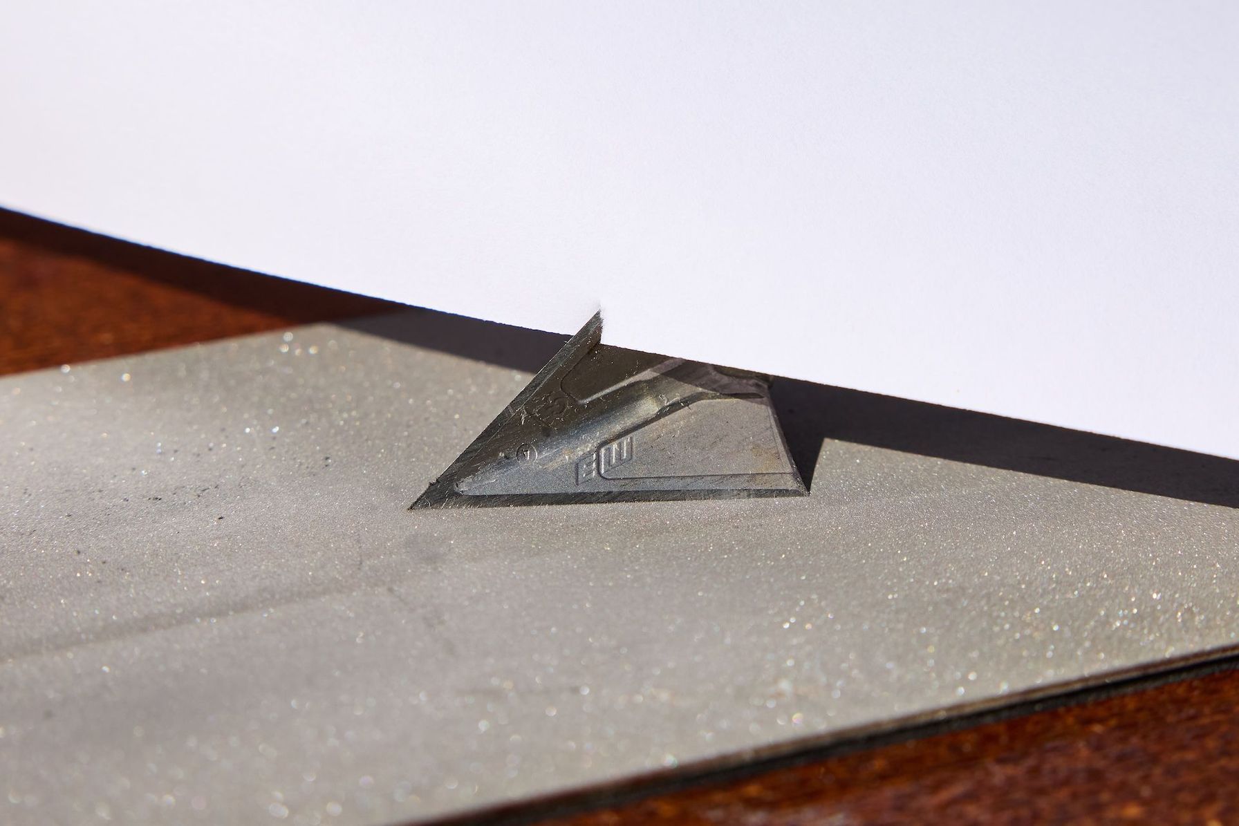 A broadhead against paper, how to test broadhead sharpness concept.