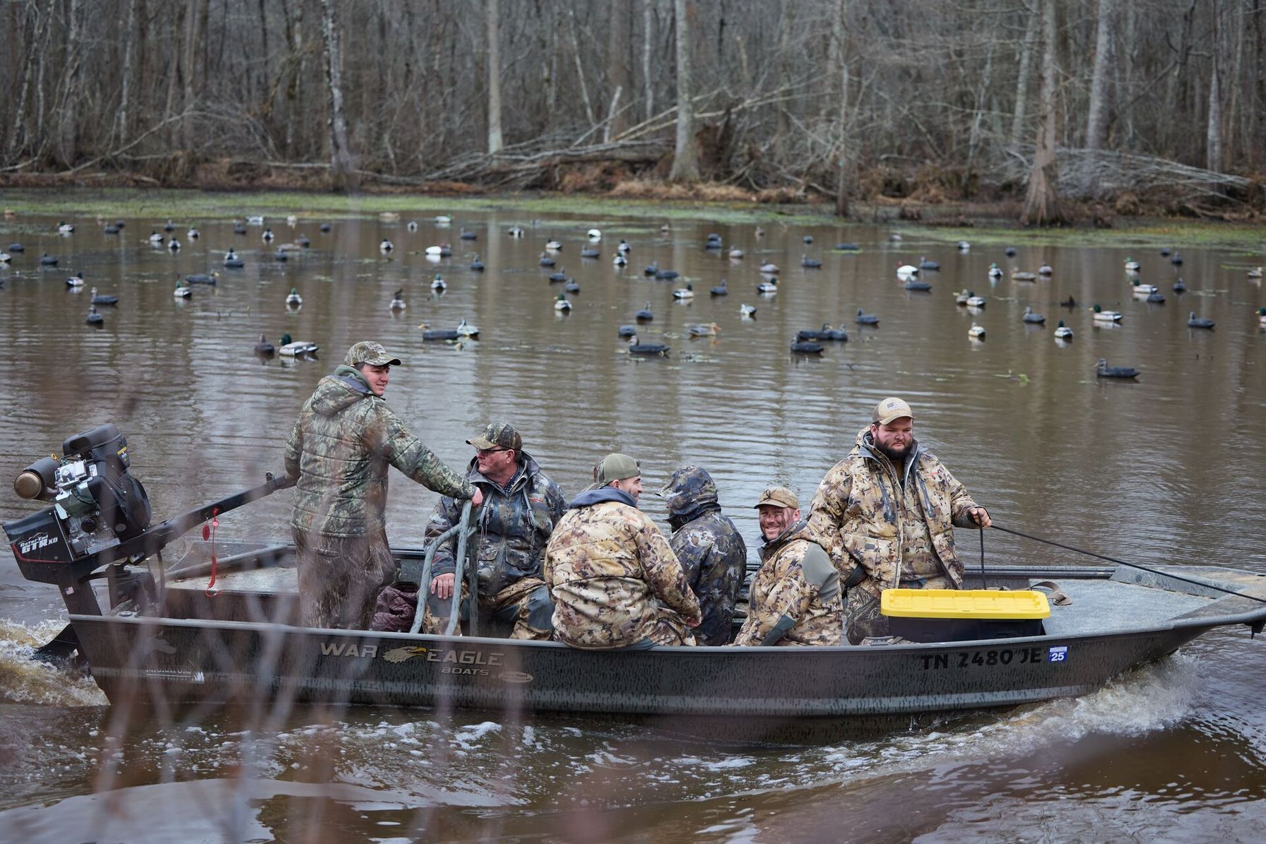 Hunters in a boat on the water for a duck hunt.