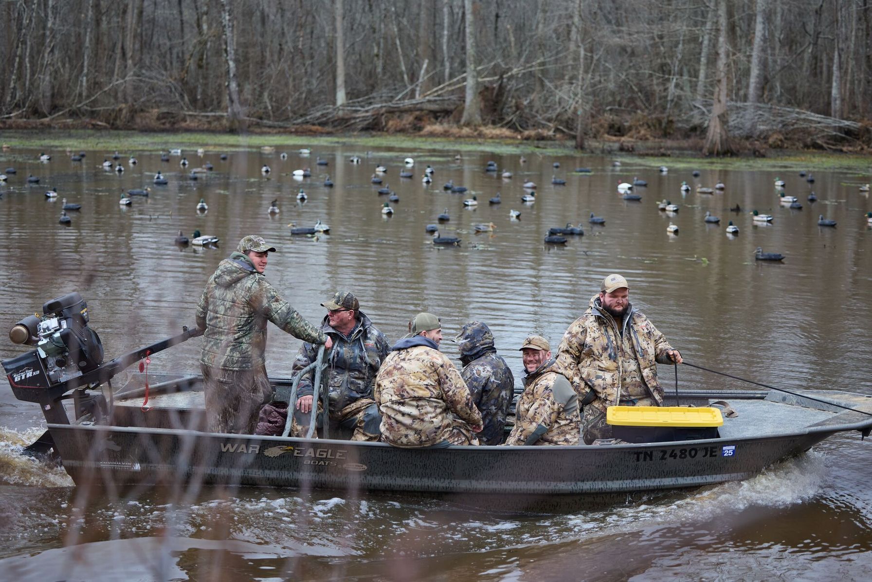 Hunters in a boat on the water for a duck hunt.