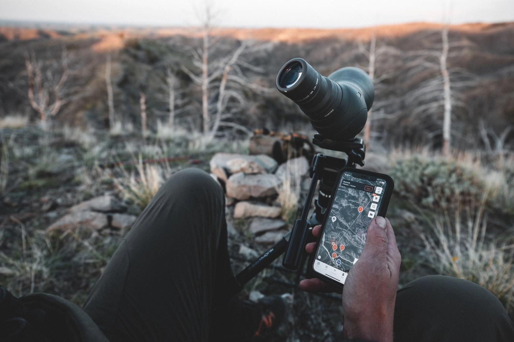 A hunter e-scouting with HuntWise, using cellular trail cams concept.