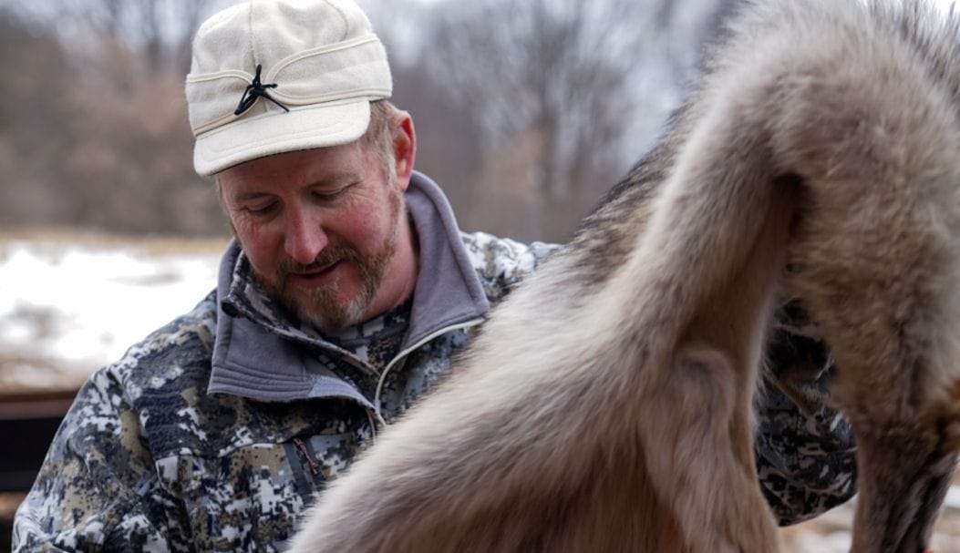 Hunter with coyote pelt, represents trapping regulations Pennsylvania