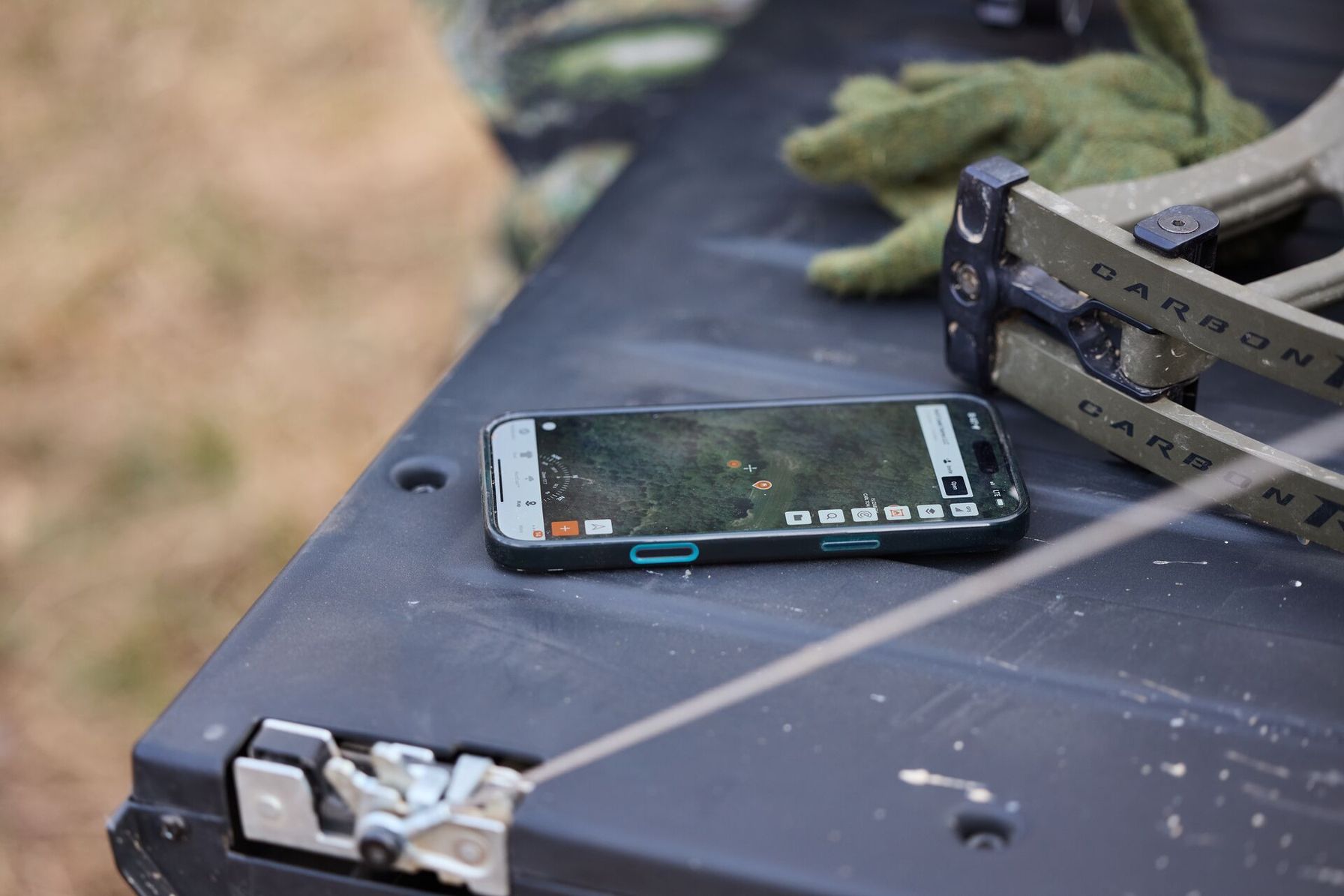 A phone showing HuntWise in a truck bed.