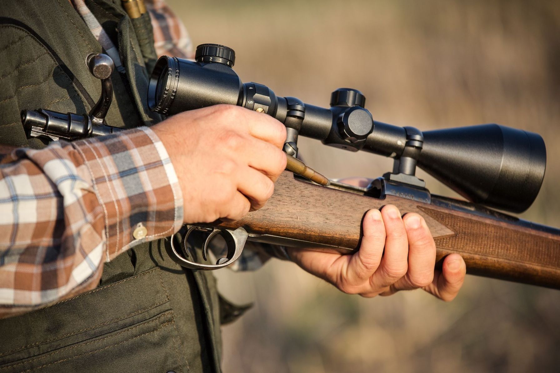 Close-up of loading bolt action rifle, types of hunting rifles concept.