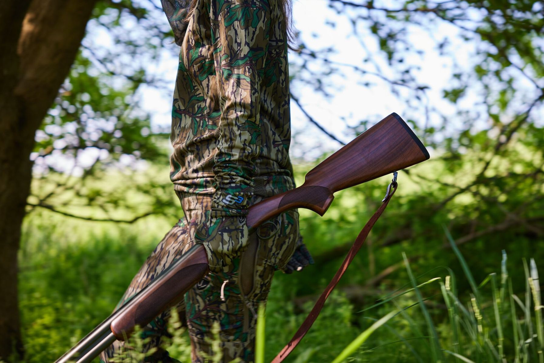 Close-up of a female hunter holding a rifle, hunting must-haves concept.