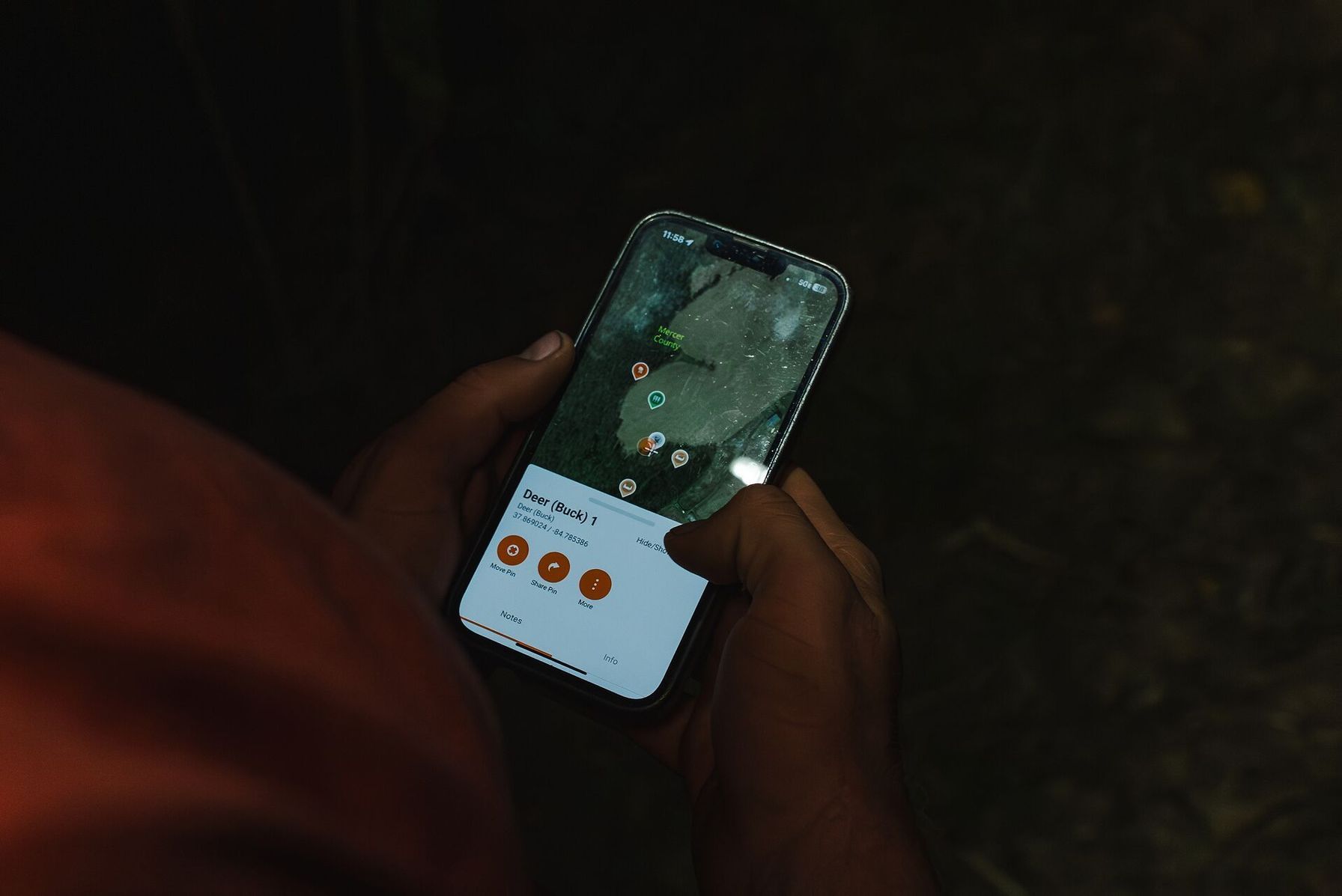 Close-up of phone showing HuntWise markers, how to see property lines while hunting concept. 