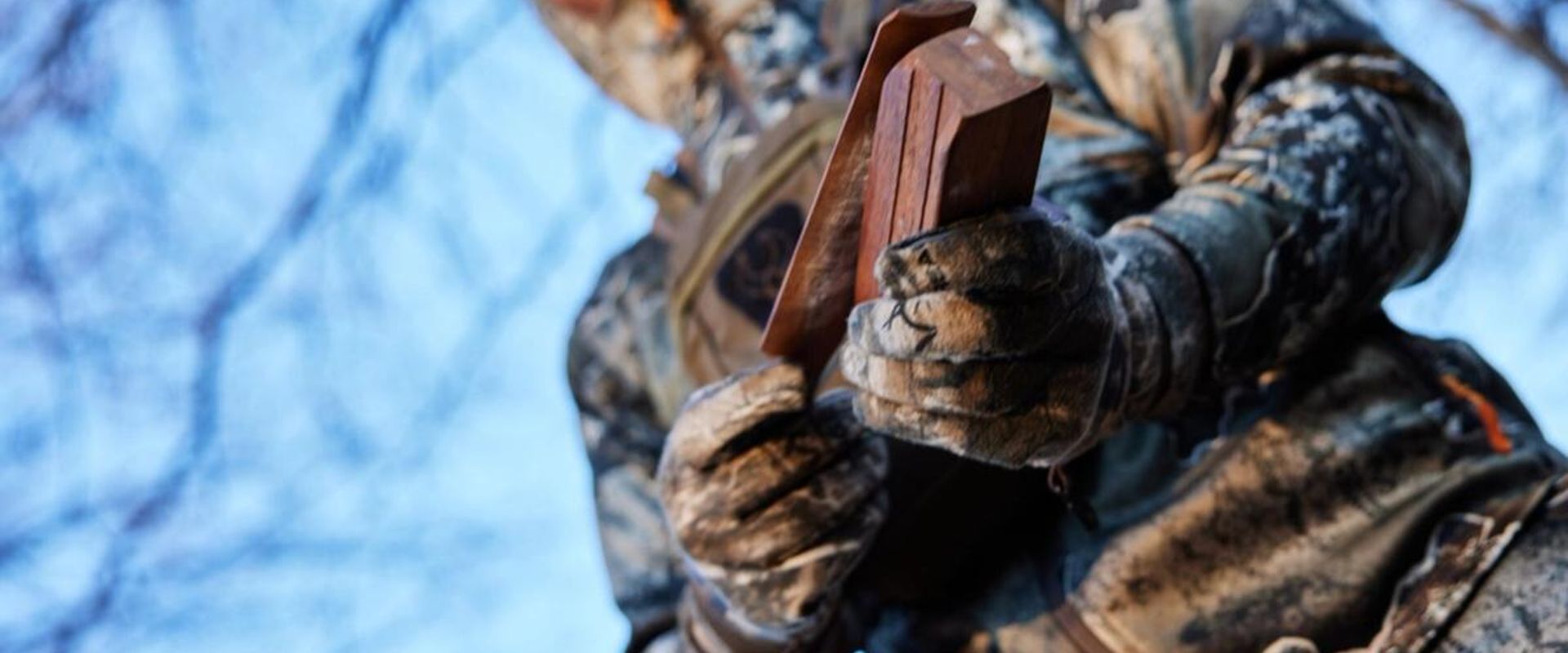 Close-up of a turkey box call in a hunter's hands, turkey box call techniques concept.