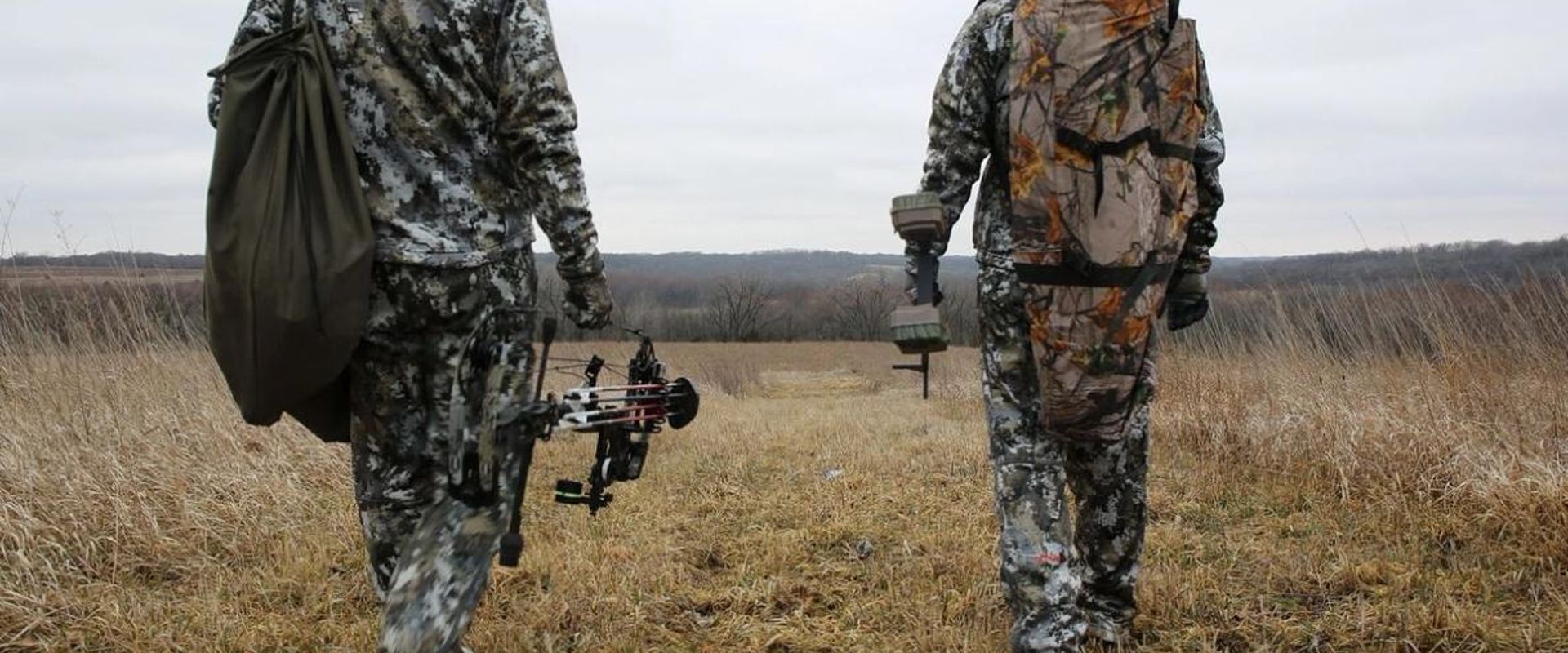 Two hunters walking in a field with text "5 Fall Hunting Tips"