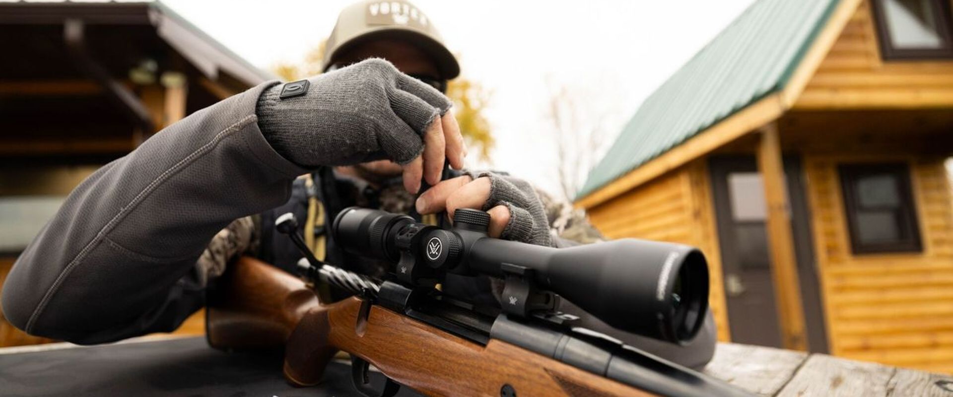 A hunter adjust a site on a hunting rifle.