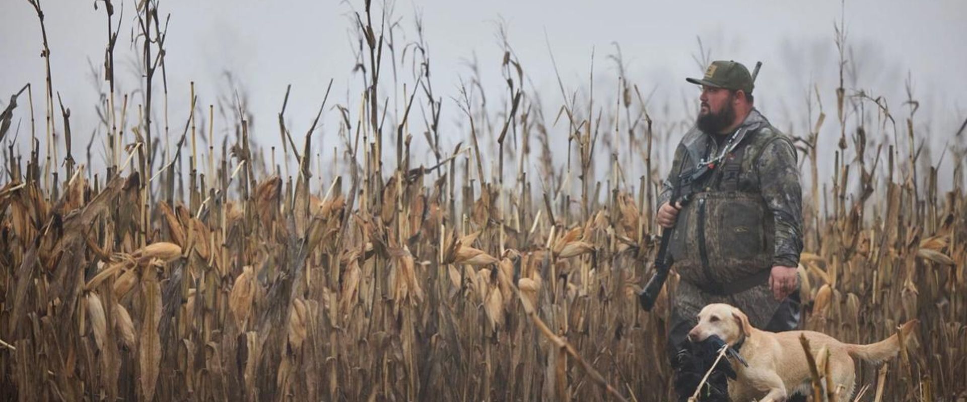 A hunter hunts waterfowl with a dog, ethics in hunting concept.
