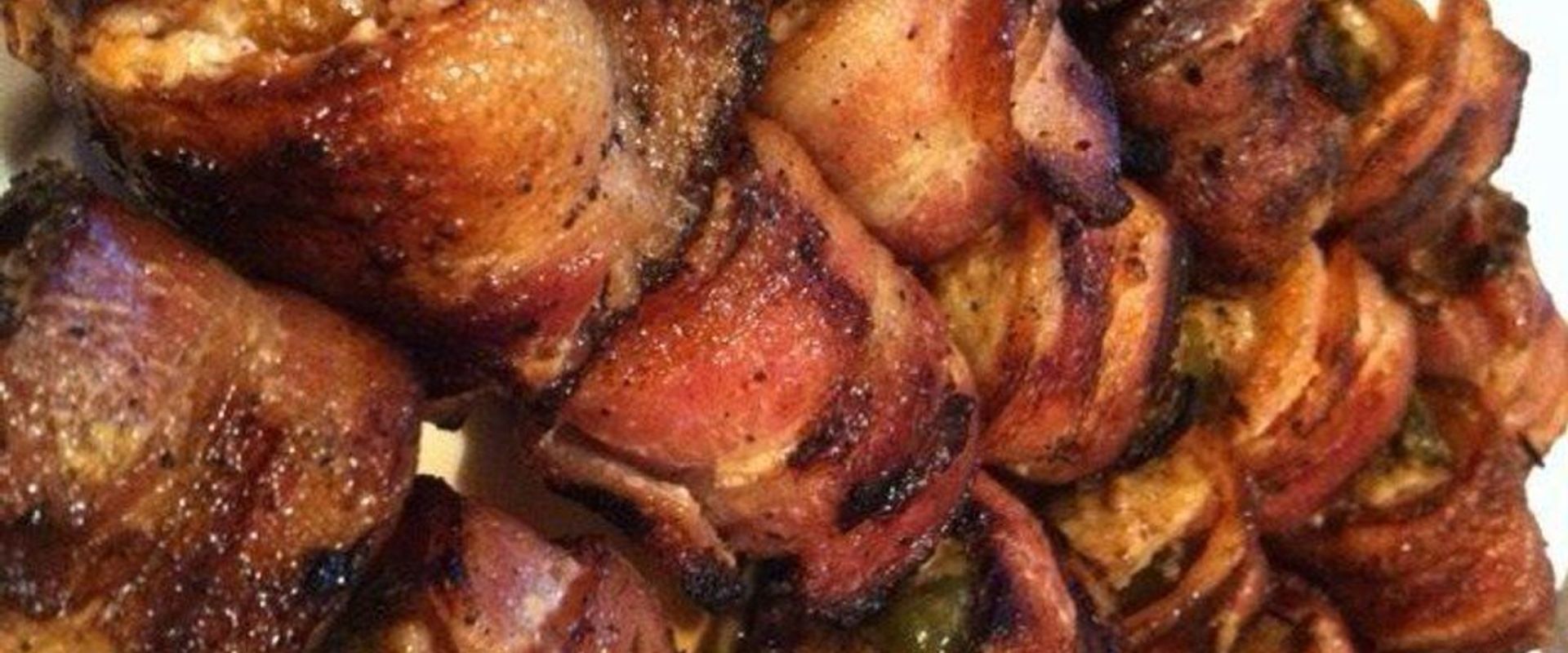 Close-up of bacon wrapped turkey rolls, wild game appetizers concept.