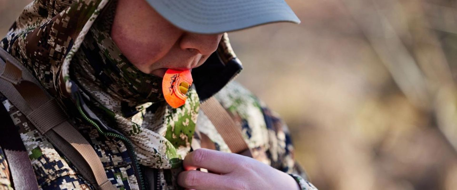 A hunter uses a turkey call, California turkey season concept.