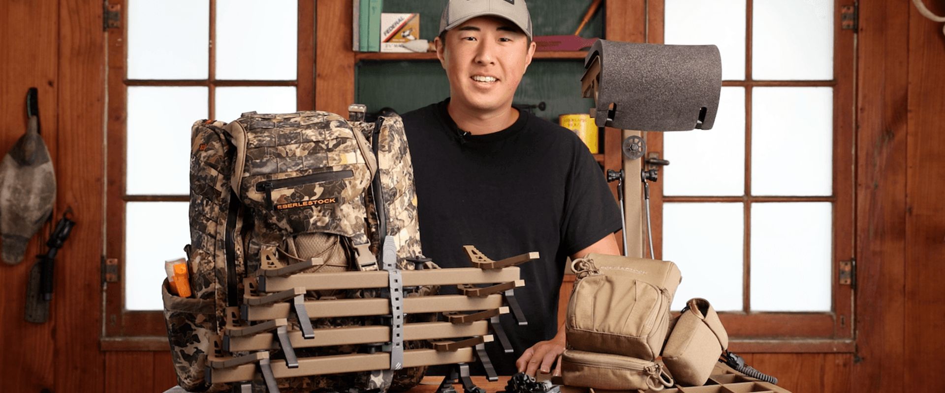 Early season hunting gear spread on a table with a hunter.