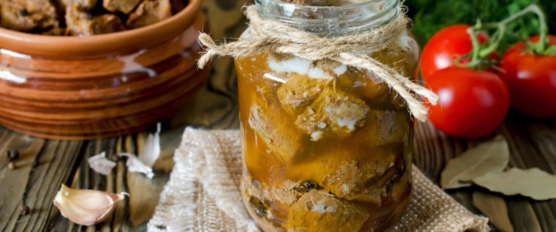 A jar of canned meat on a table, canning venison concept.