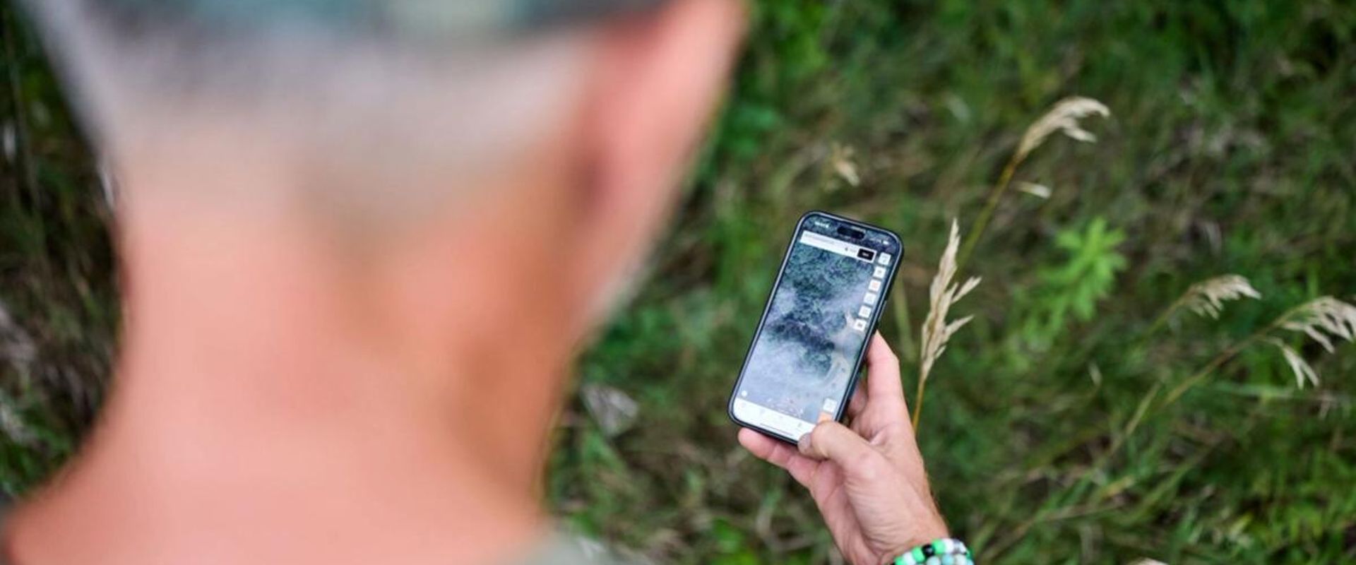 Hunter using the HuntWise land app to find where to hunt.
