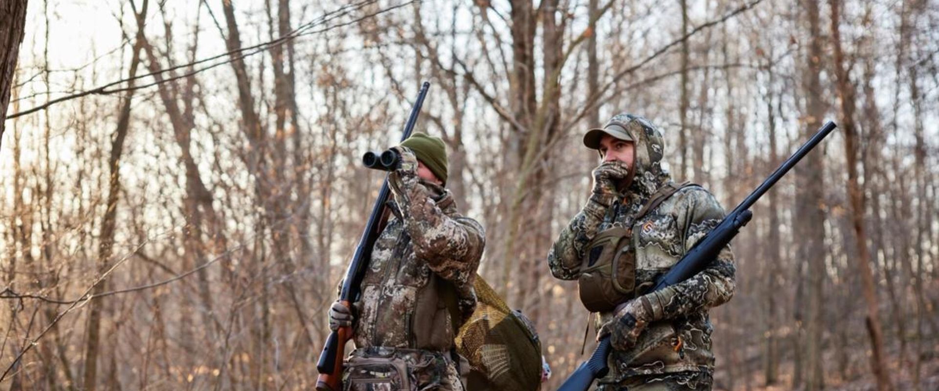Hunters in the field looking for game, get an Arkansa hunting license concept.