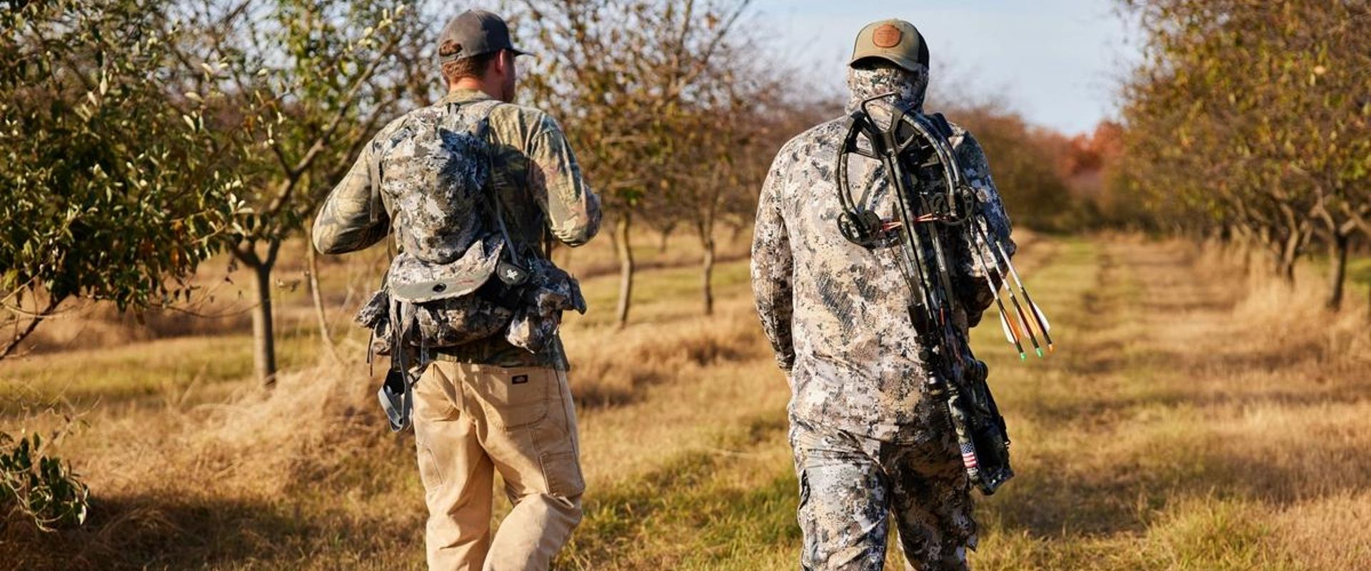 Two hunters walk with gear, how to find walk-in hunting in Wisconsin concept. 
