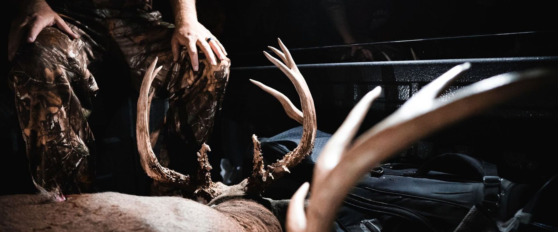 Hunter with buck deer in back of truck, Louisiana deer season 2026 concept.