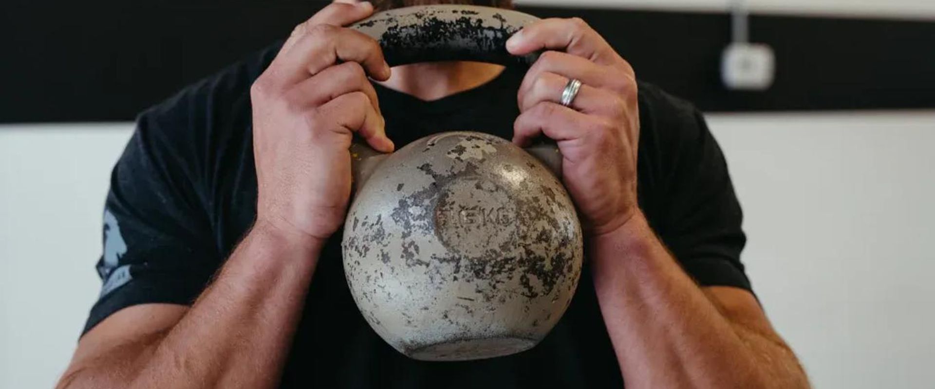 A man holds a dumbbell, hunting exercises to stay in shape concept.