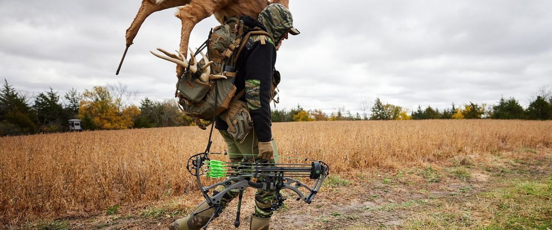 A hunter carries a deer decoy for a hunt.