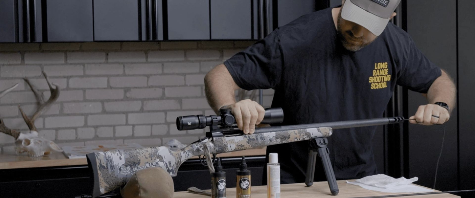 Hunter cleaning a rifle, post season rifle care concept.
