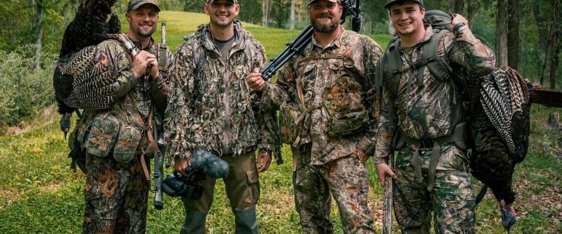 The four members of The Untamed wearing hunting camo.