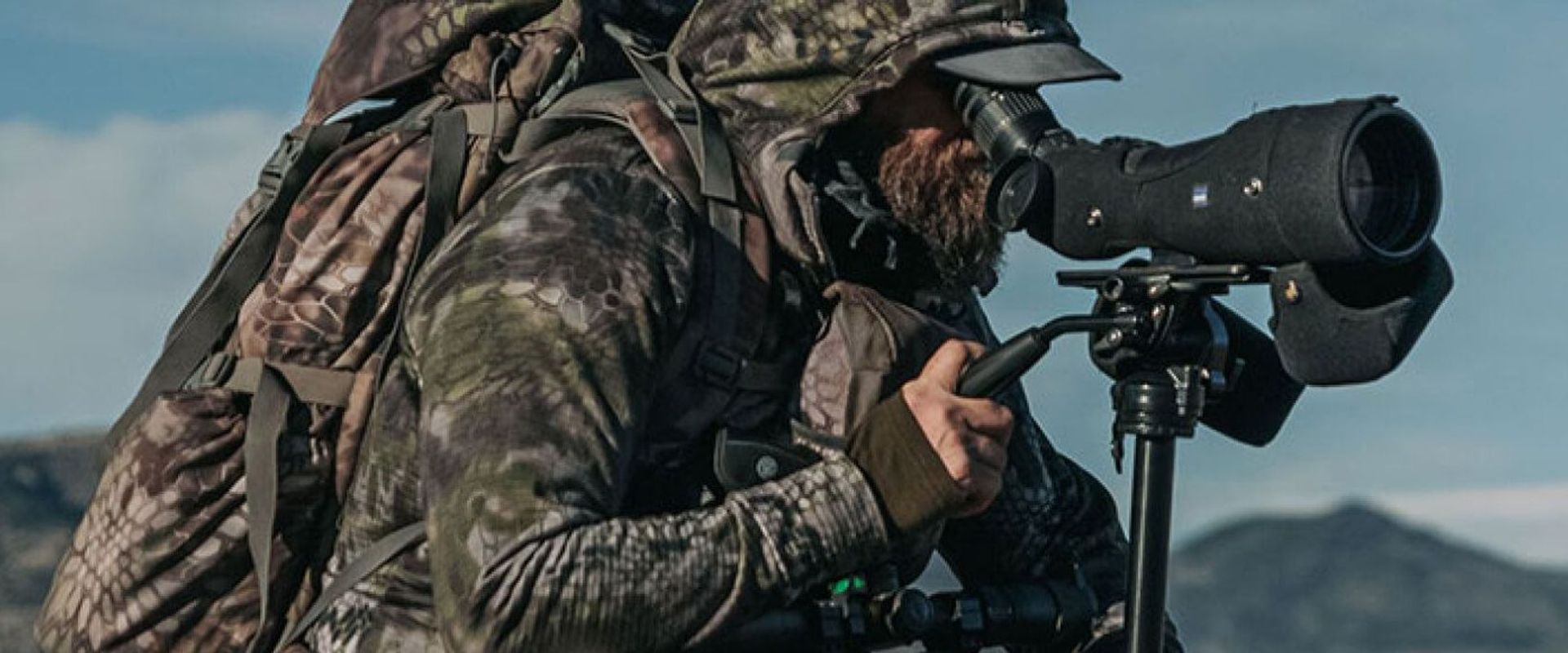 A hunter in camp use a spotting scope, best spotting scopes concept.