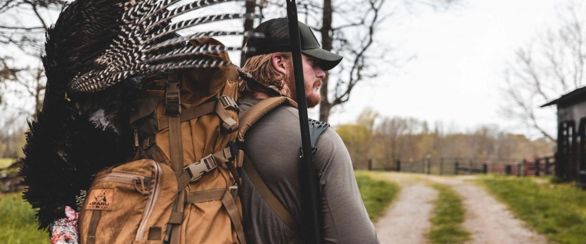 A hunter with a harvested turkey after a successful turkey hunt.