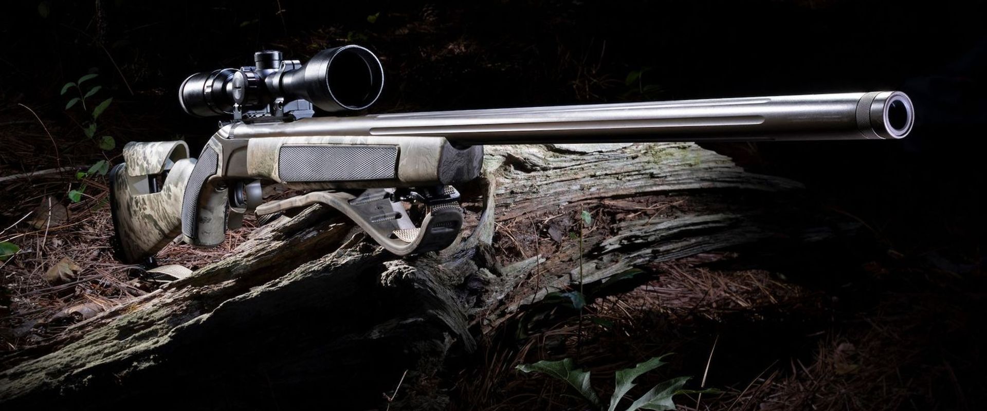 Muzzleloader with scope on log, how to hunt with a muzzleloader concept.