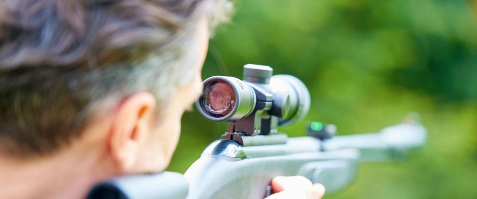 A man aims an air rifle.