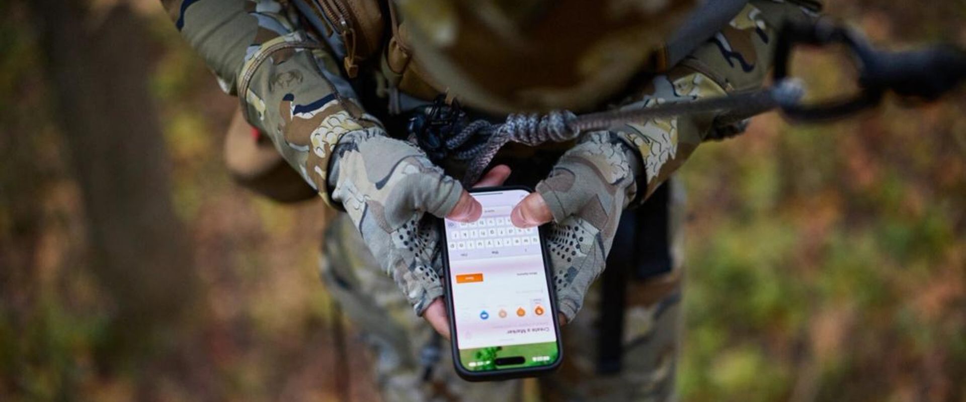 Hunter used HuntWise on phone while in tree saddle, how to use a hunting app concept.
