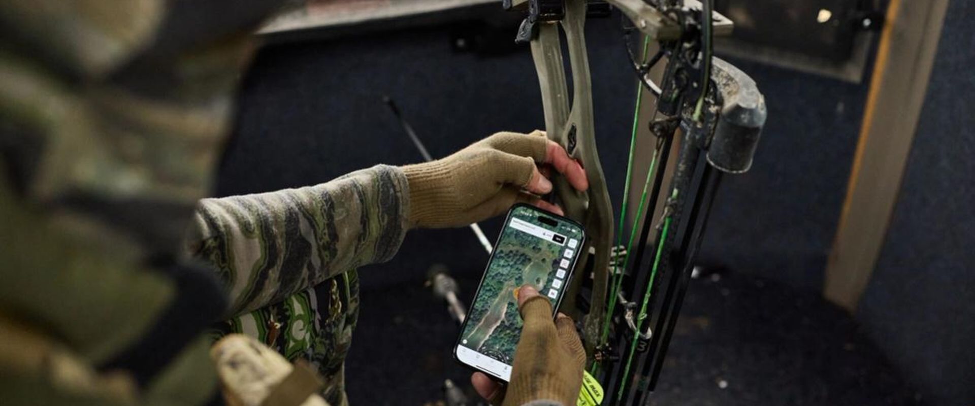 Hunter using topographic map in HuntWise, find public deer hunting land near me concept.