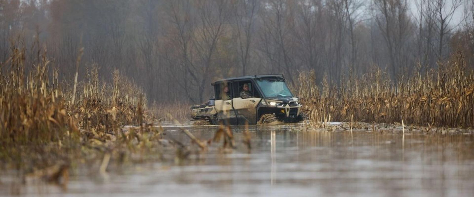 Hunters in an ATV in a duck habitat, building a duck pond concept.