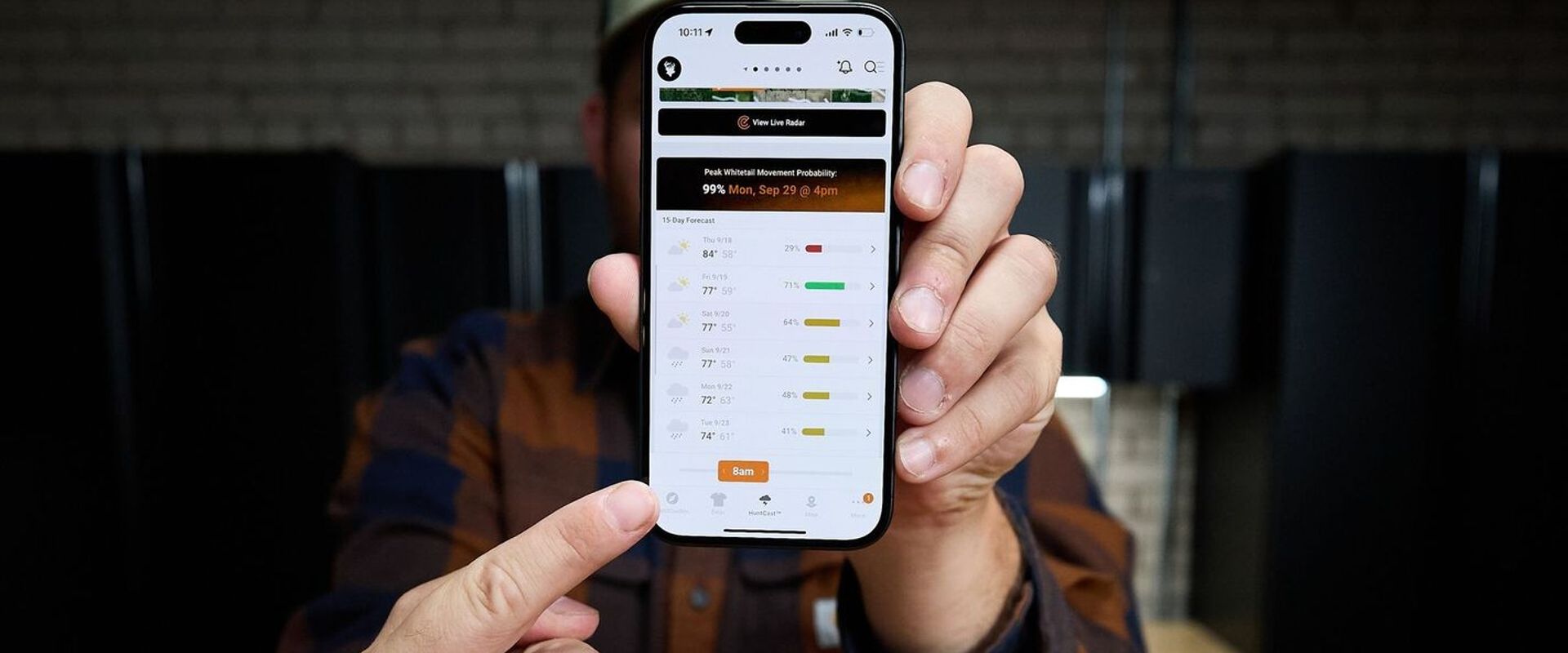 Hunter points at HuntWise HuntCast on phone screen, HuntCast vs weather apps concept.