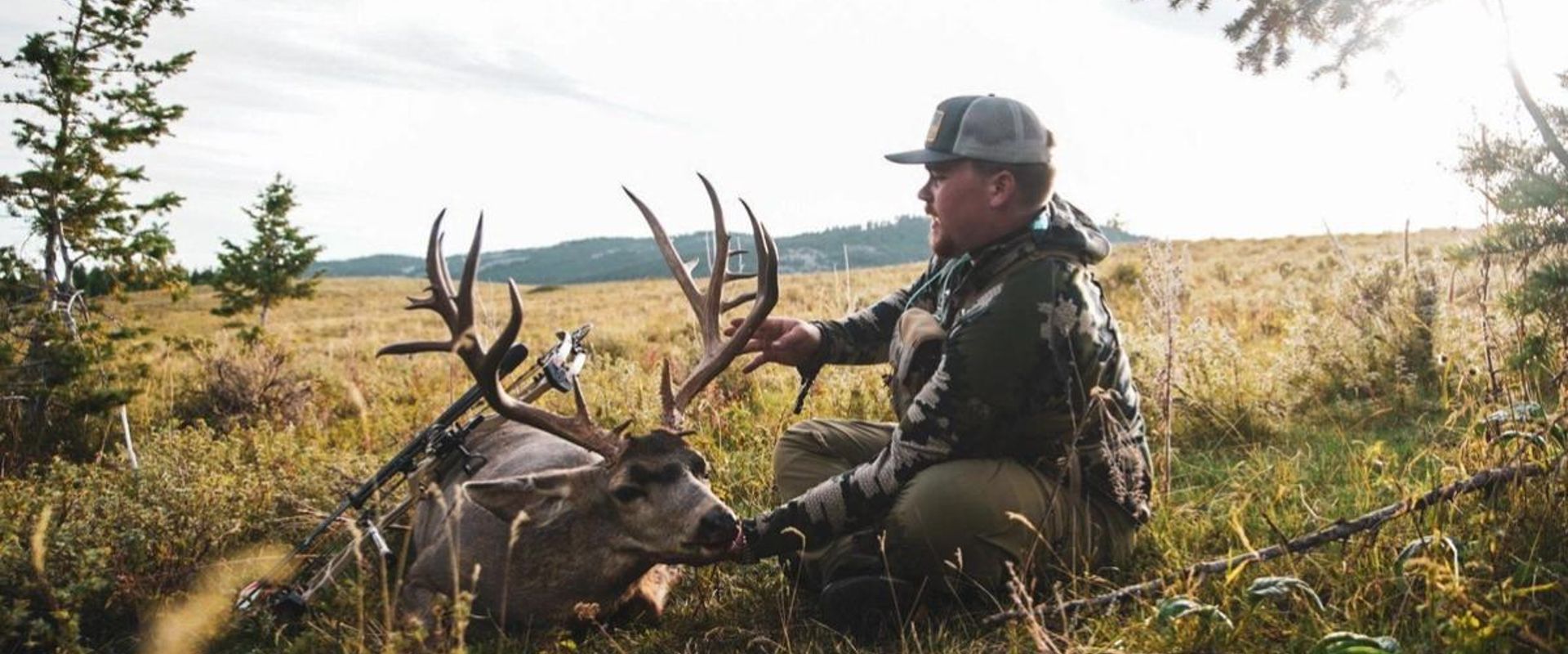 A hunter holds up the head of a deer kill, finding big bucks on public land concept.