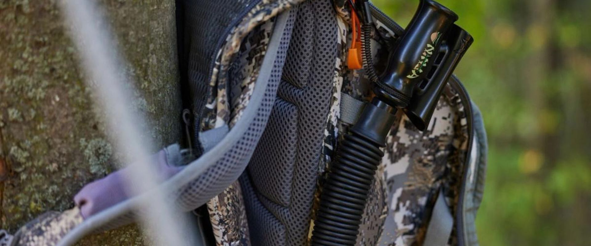 A deer grunt call on a hunter's pack, use the best deer grunt call tips concept.