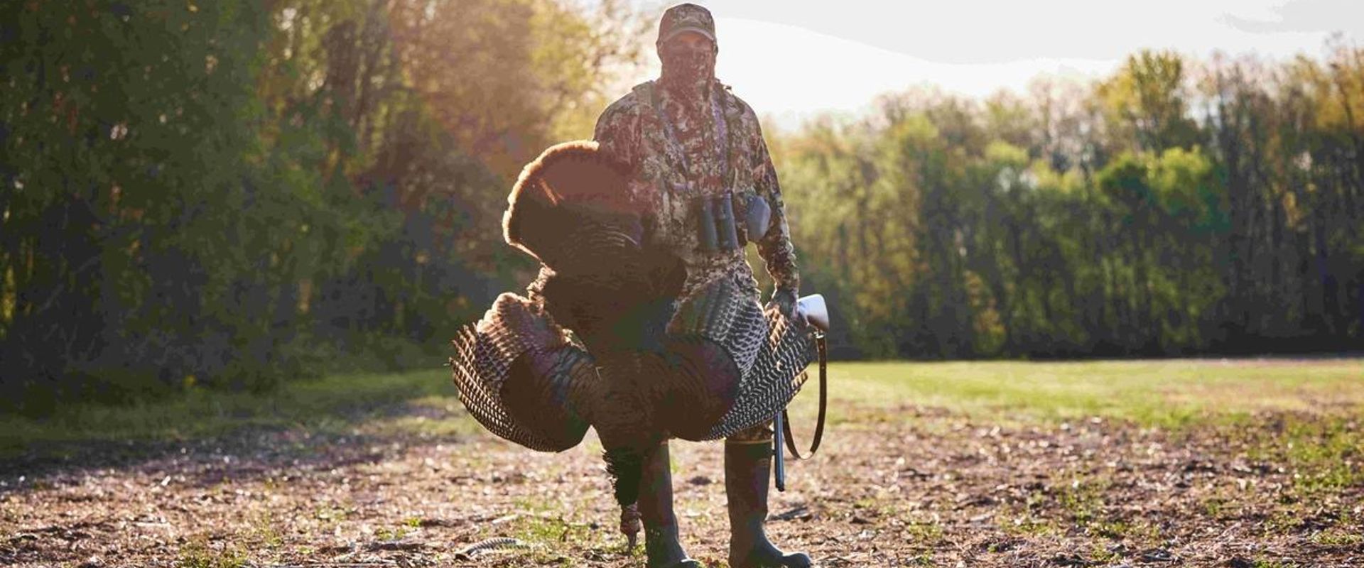 A hunter with a turkey after a hunt, when is NC turkey season concept.