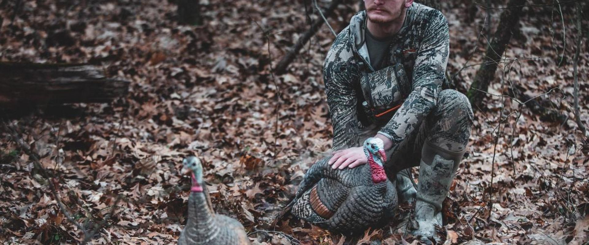 A hunter with a turkey, turkey hunting concept.