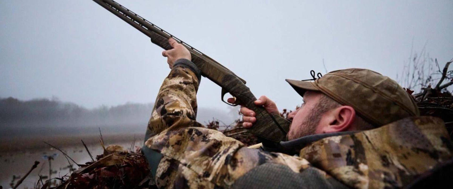 Hunter aiming a shotgun for duck hunt, MN duck opener 2025 concept.