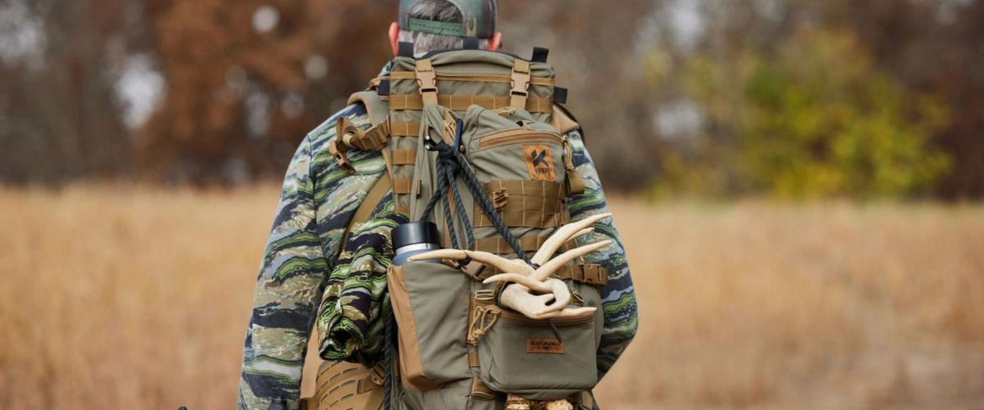 A hunter carries a pack with antler sheds, where to find deers sheds concept.