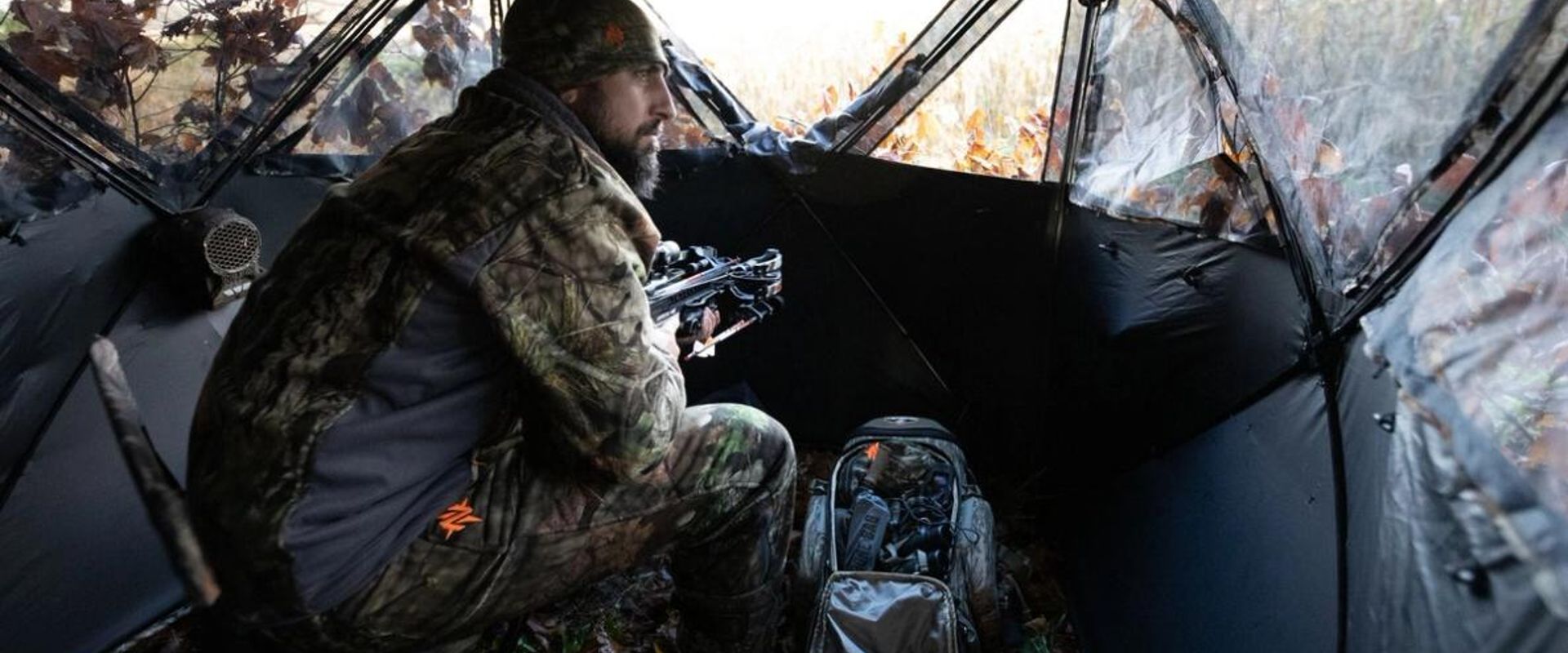 A hunter sits in a ground blind, getting a Georgia hunting license concept.