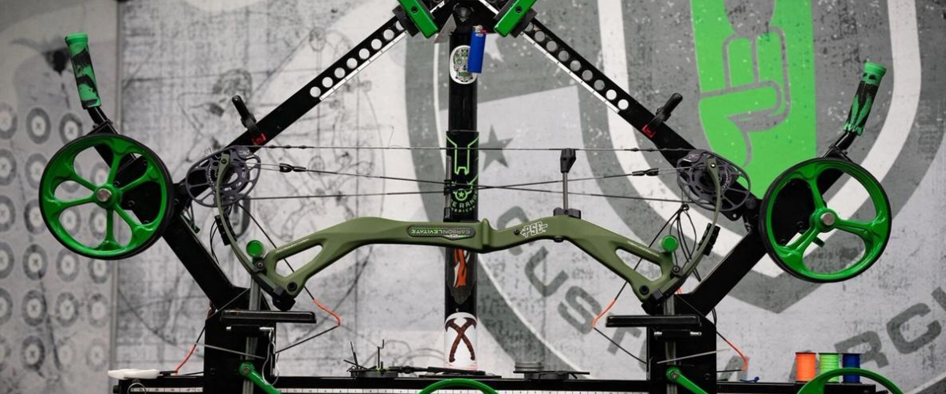 A compound bow on a stand for maintenance.