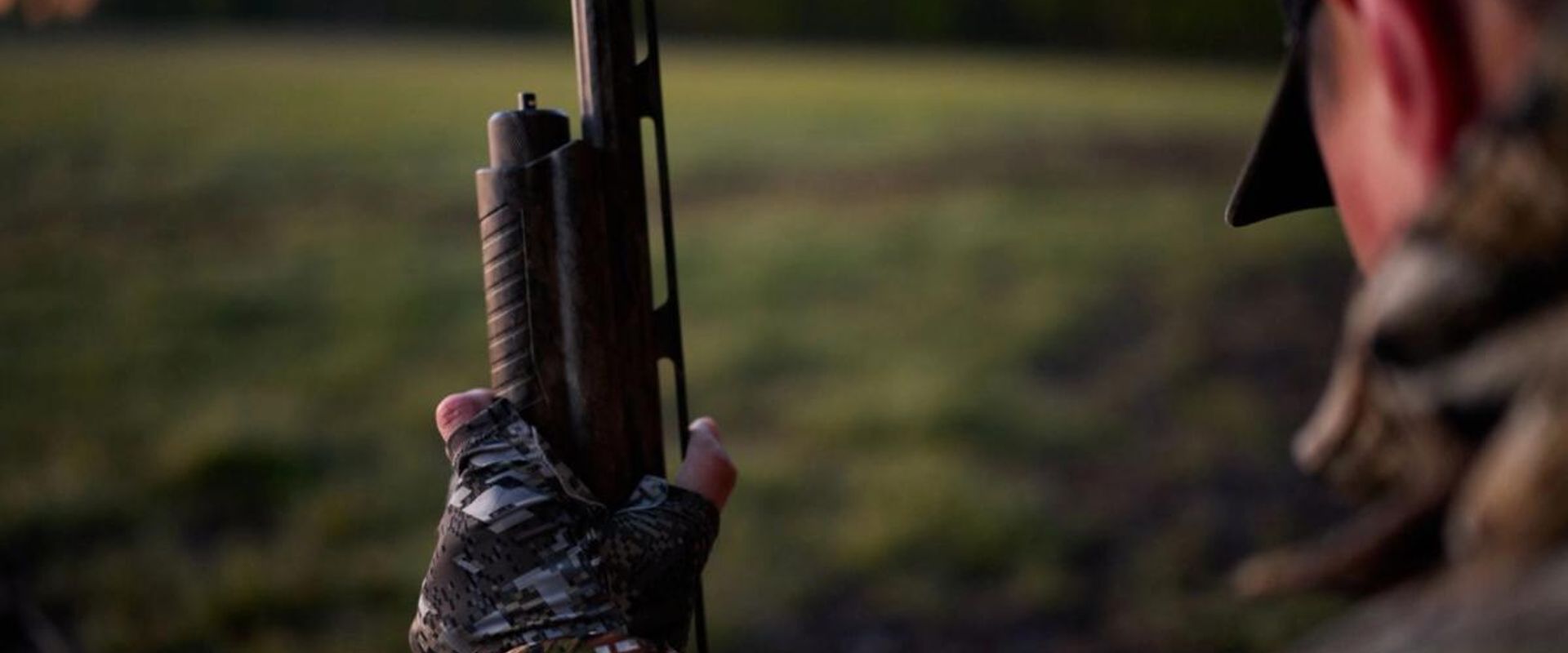 Hunter with shotgun and HuntWise app, best dove hunting shotgun concept.