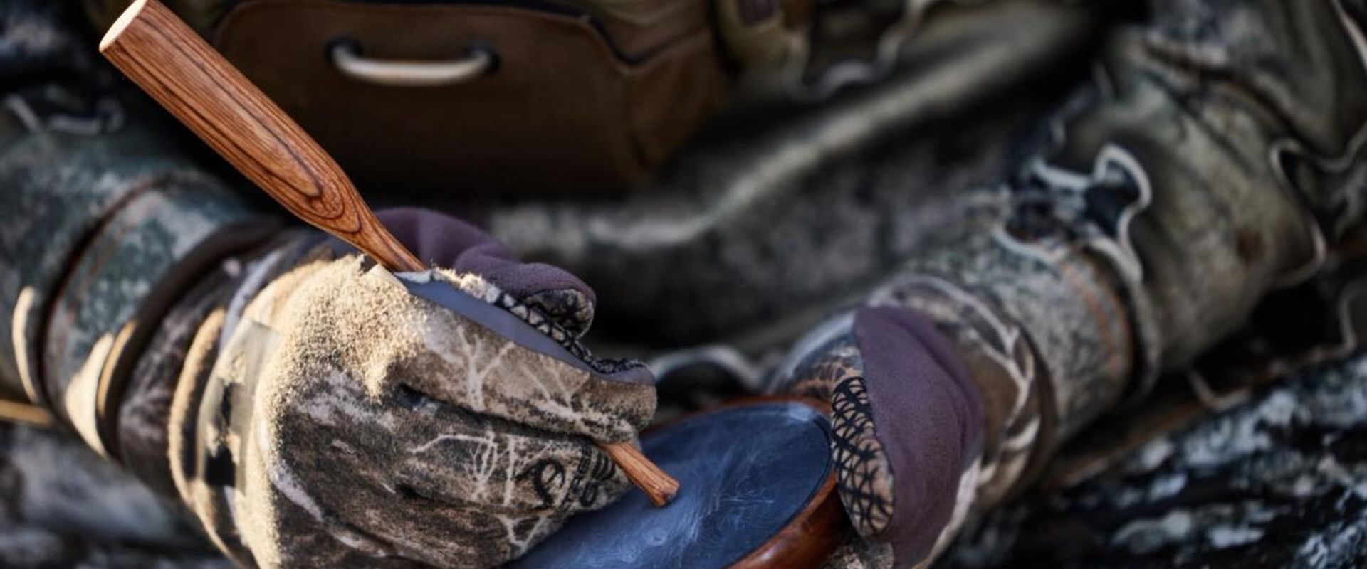 A hunter with camera equipment using HuntWise in the field, hunting influencer concept.