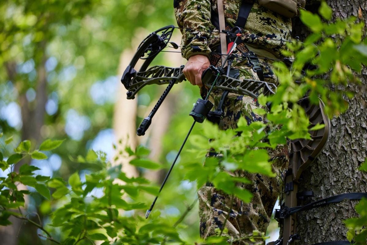 Close-up of a hunter holding a bow at his side, PA archery season concept.