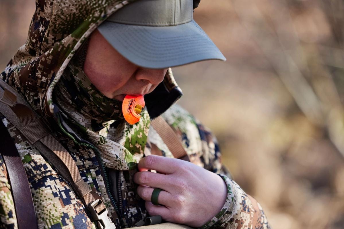 A hunter uses a turkey call, California turkey season concept.