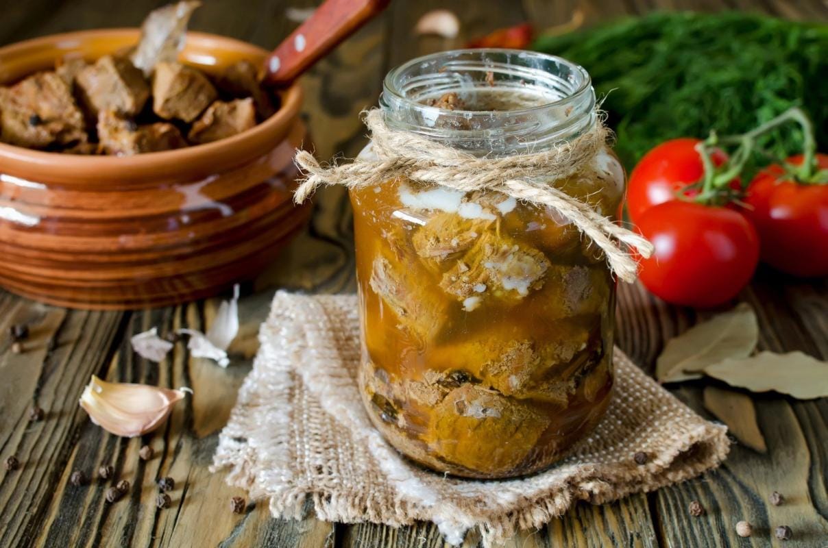 A jar of canned meat on a table, canning venison concept.