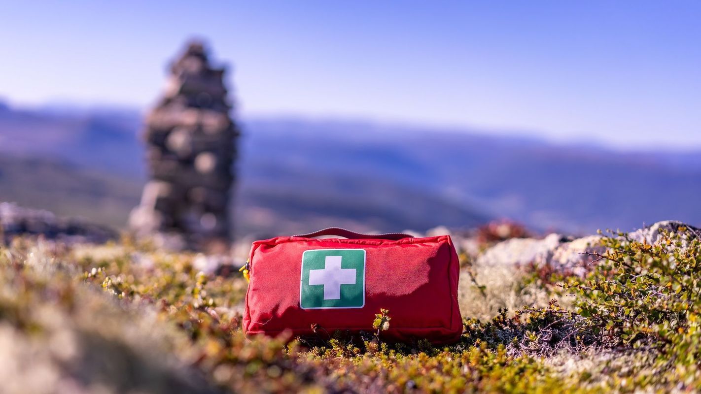 A first aid kit on the ground, hunting first aid kit concept.