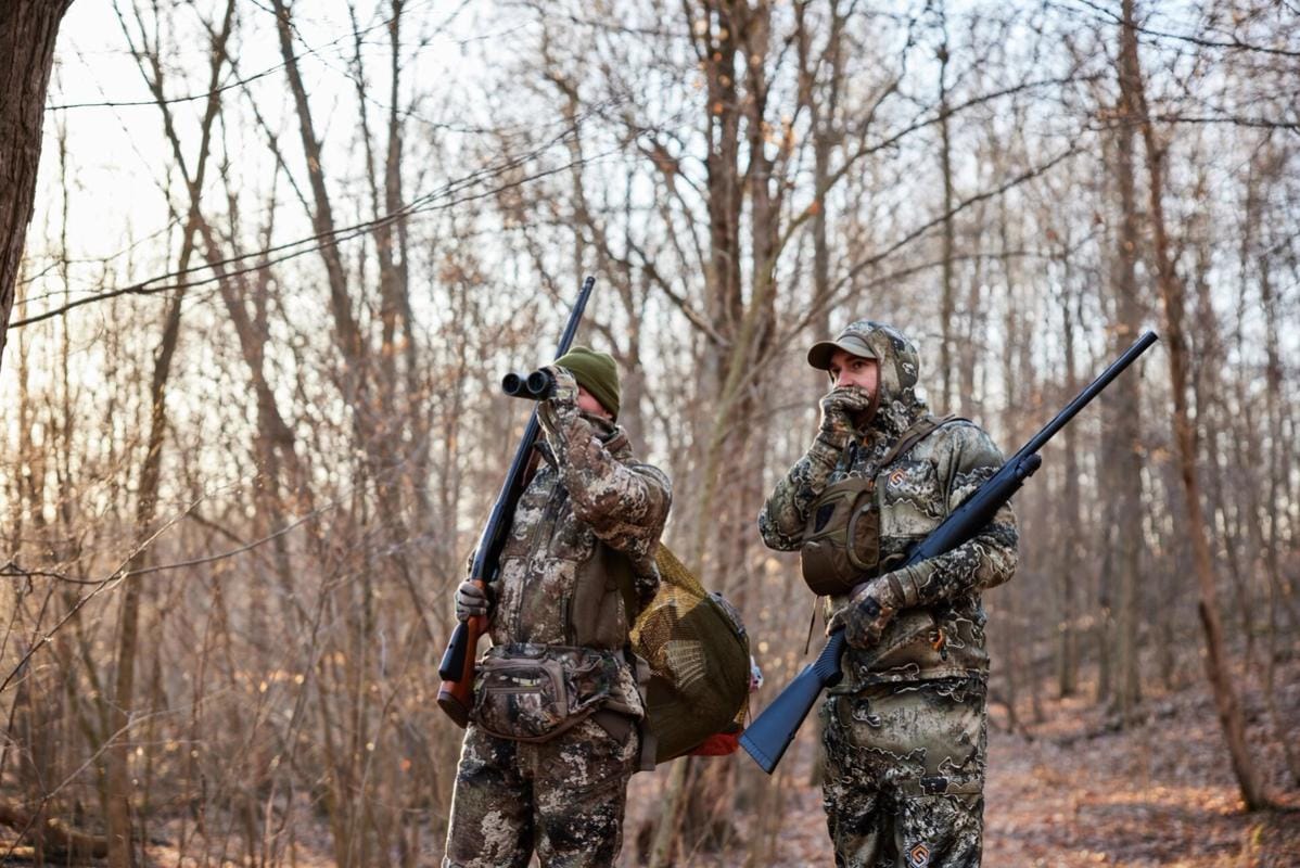 Hunters in the field looking for game, get an Arkansa hunting license concept.