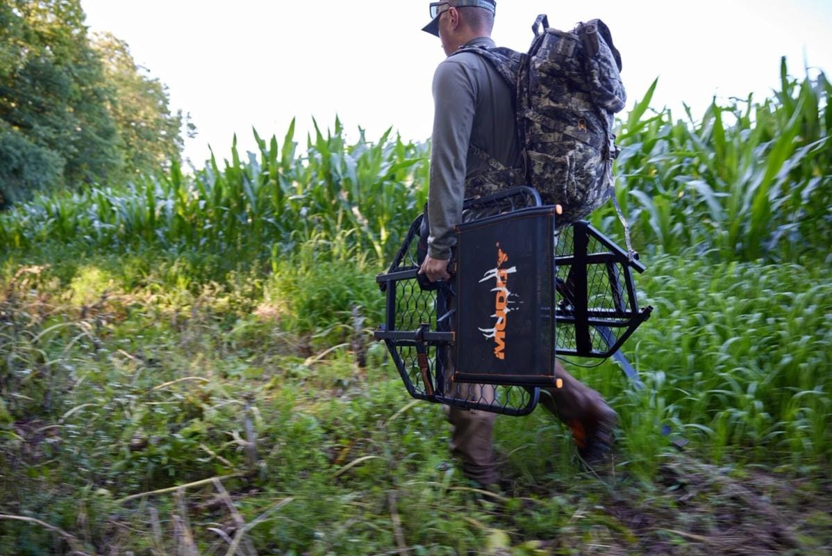 A hunter carries gear and a tree stand to set up for Missouri deer season.