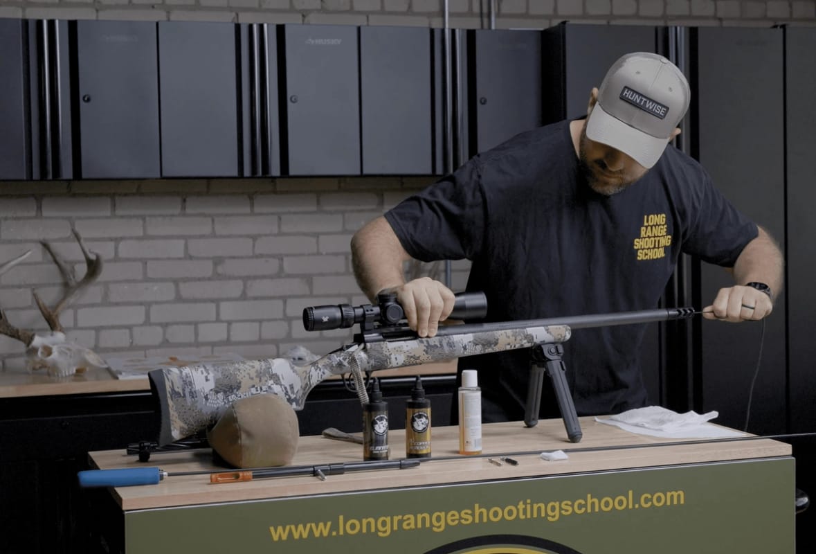 Hunter cleaning a rifle, post season rifle care concept.